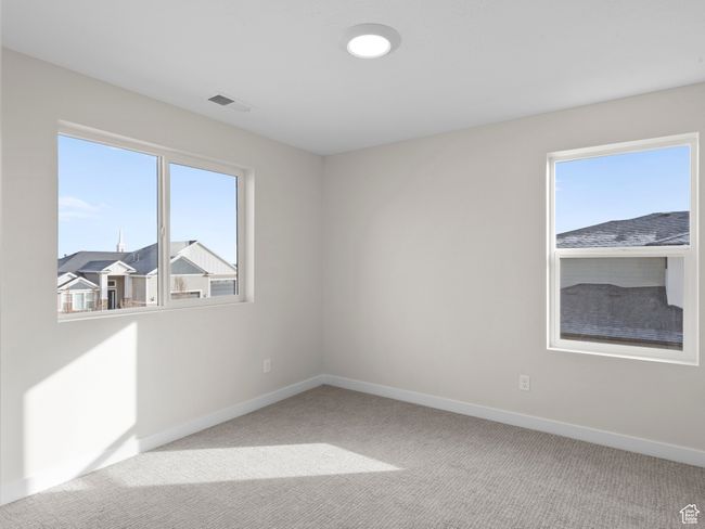 Unfurnished room with a healthy amount of sunlight, visible vents, and light colored carpet | Image 16
