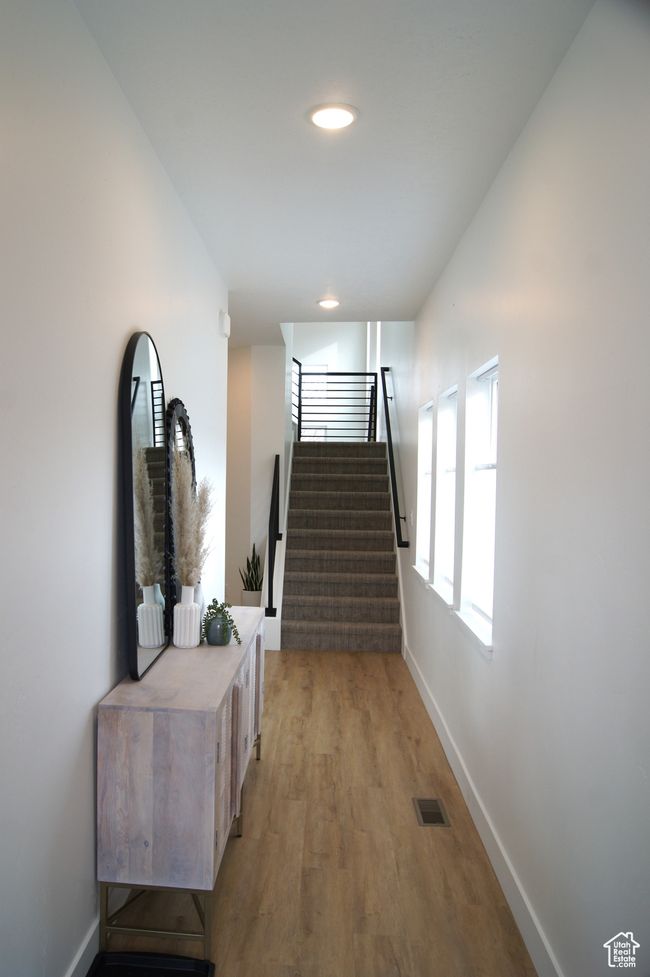 Corridor featuring stairway, baseboards, light wood-style floors, and recessed lighting | Image 6