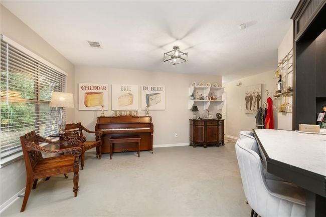 The adjacent space is filled with natural light and offers room for a buffet table or your own unique setup—ideal for everyday function or entertaining. | Image 6