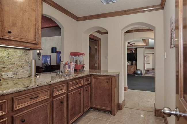 Convenient service bar with sink off the media and gameroom | Image 29