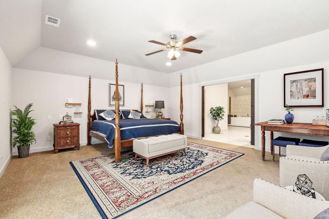 Bedroom featuring light carpet, connected bathroom, ceiling fan, and lofted ceiling | Image 23