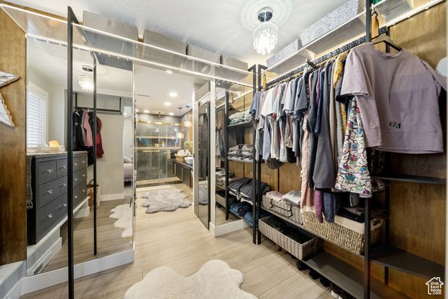 Walk in closet featuring wood finished floors | Image 15