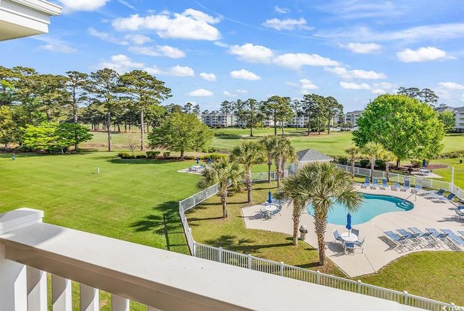 Community pool featuring a patio area, a yard, and fence | Image 25