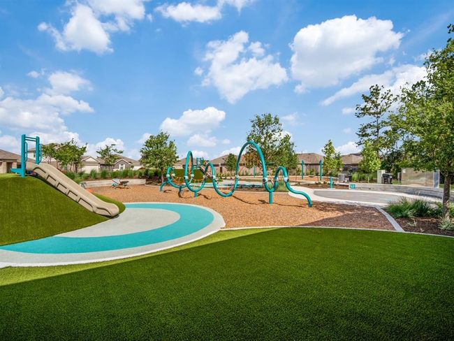 A vibrant community playground featuring a slide, modern climbing structures, and well-maintained green spaces. Perfect for families and outdoor activities. | Image 15
