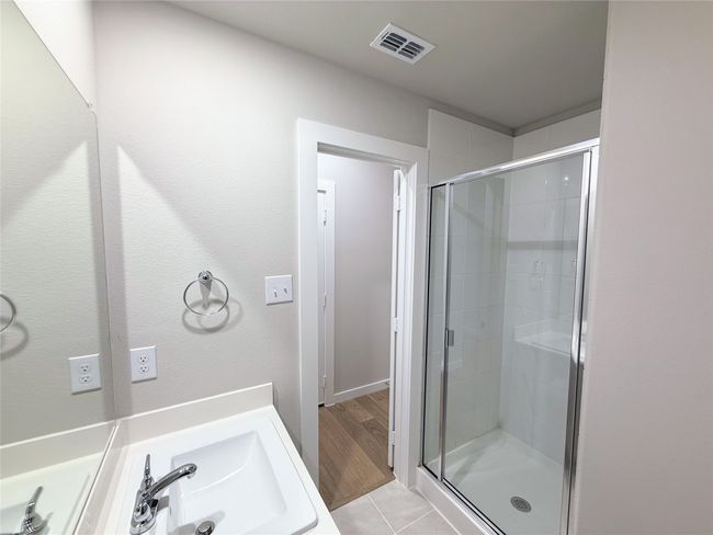 Bathroom featuring a shower stall and tile patterned flooring | Image 26