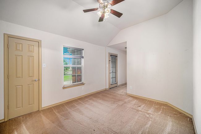 Unfurnished room with carpet flooring, a ceiling fan, vaulted ceiling, and baseboards | Image 21