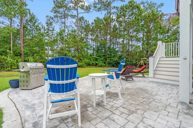 View of patio featuring grilling area and view of scattered trees | Image 22