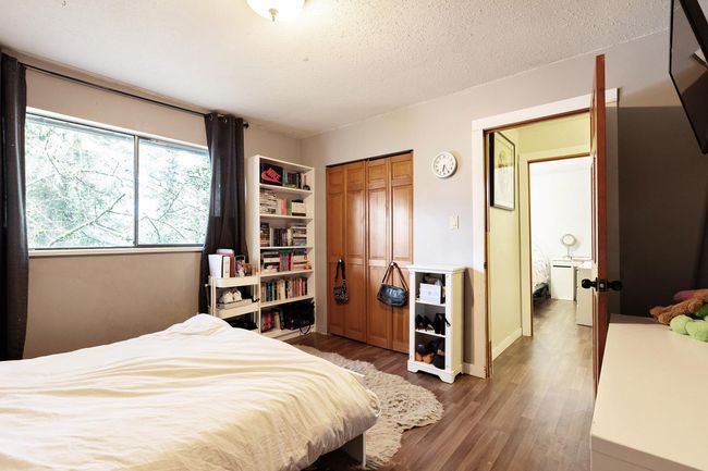 Bedroom featuring wood finished floors, a closet, and a textured ceiling | Image 21