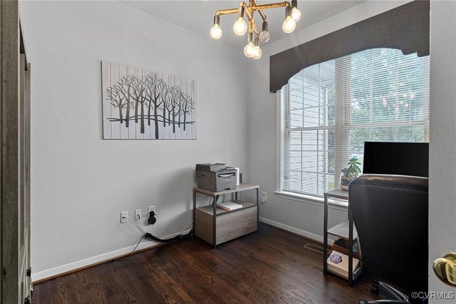 Home office with an inviting chandelier, wood finished floors, and baseboards | Image 25