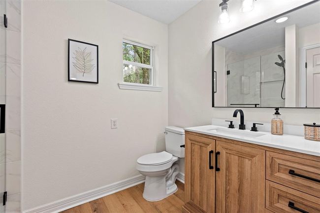 Master bathroom - new vanity, faucets and hardware, luxury vinyl plank flooring, & spacious new shower | Image 13