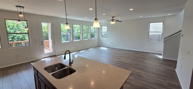 Kitchen featuring healthy amount of natural light, a ceiling fan, dark wood-style flooring, and recessed lighting | Image 12