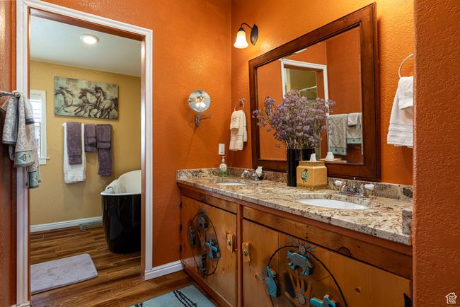 Bathroom with vanity, a bath, and hardwood / wood-style floors | Image 14