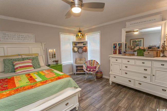 Bedroom with dark wood-style floors, baseboards, and ornamental molding | Image 27