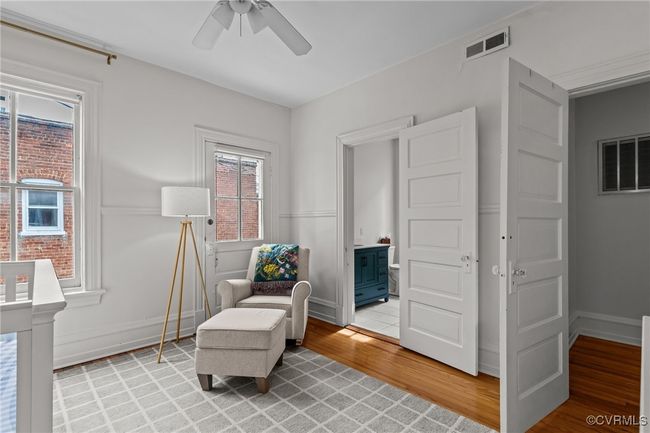 Living area featuring light wood-type flooring, baseboards, visible vents, and ceiling fan | Image 29