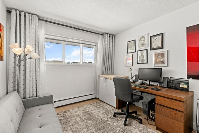 Home office featuring baseboard heating, a textured ceiling, and light wood-style floors | Image 18