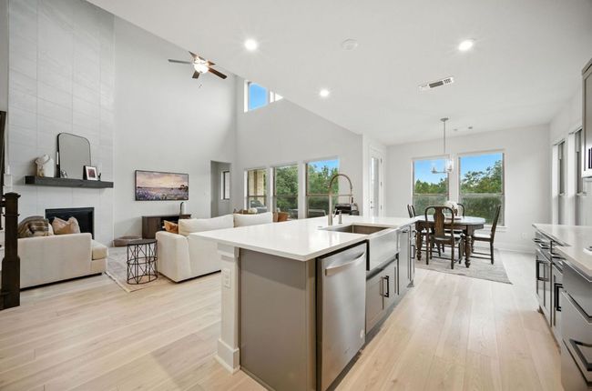 Kitchen with dishwasher, light wood-type flooring, healthy amount of natural light, recessed lighting, and a towering ceiling | Image 14