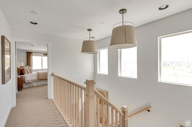 Hallway with an upstairs landing and light colored carpet | Image 21