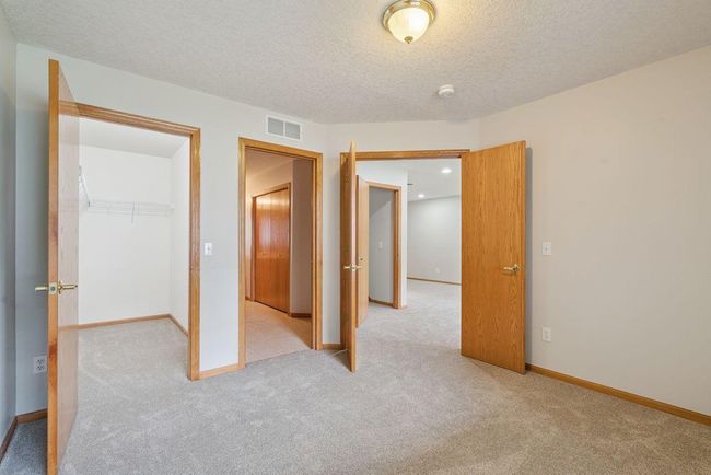 Large owner suite bedroom with spacious walk in closet, french doors, private on-suite bath with separate shower & soaking tub. | Image 11