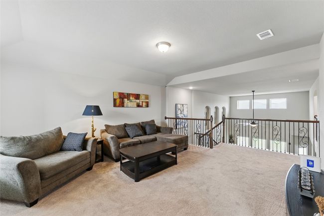 Living room with light carpet, visible vents, and lofted ceiling | Image 25