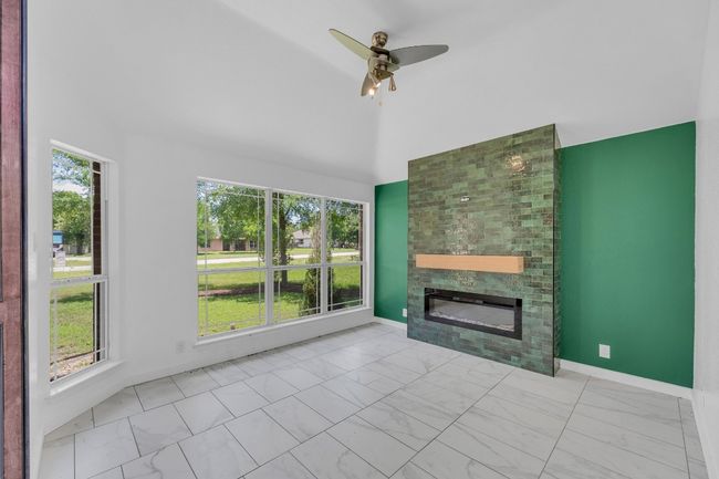 Den, sitting room with an electric fireplace | Image 23