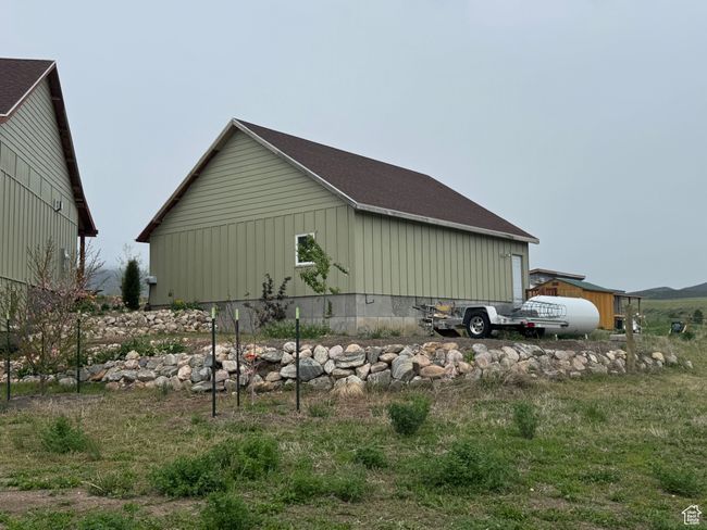 View of side of home with board and batten siding and roof with shingles | Image 21