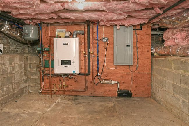 Utility room featuring water heater and electric panel | Image 40