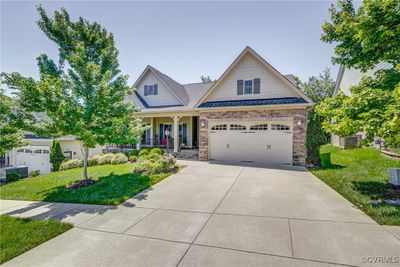 Craftsman-style home with a front yard and a garage | Image 1