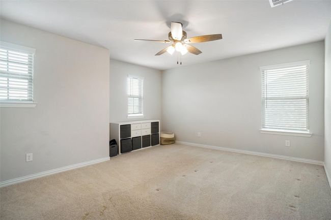 Spare room with ceiling fan, carpet, and baseboards | Image 17