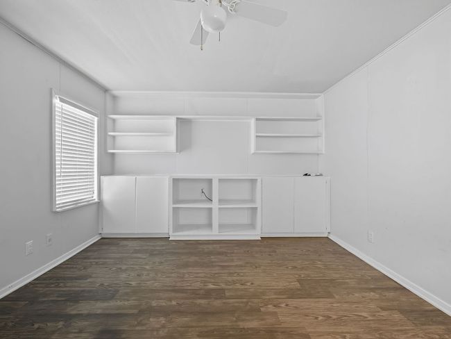 Spare room featuring dark wood finished floors and ceiling fan | Image 18