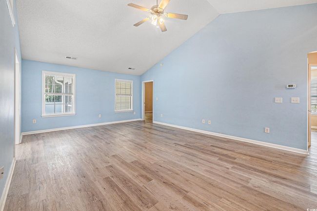 Unfurnished room with ceiling fan, light wood-type flooring, and high vaulted ceiling | Image 8