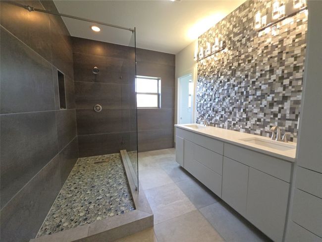 Bathroom with a walk in shower, double vanity, recessed lighting, and tile patterned floors | Image 21