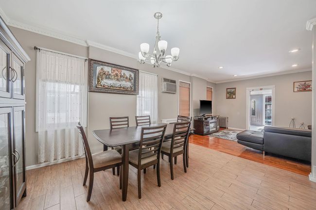 Dining area with a chandelier, an AC wall unit, recessed lighting | Image 11