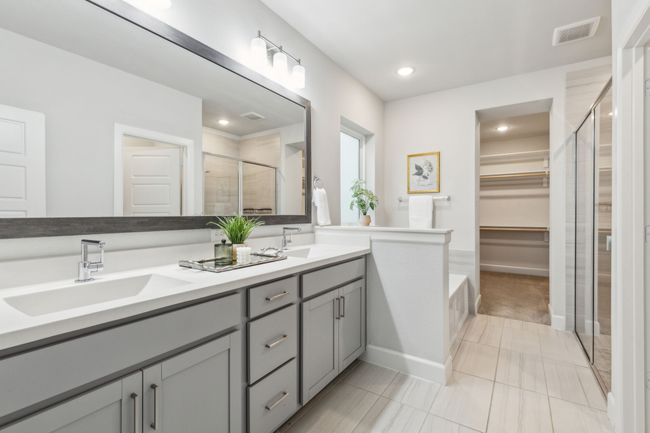 Full bath featuring a stall shower, a walk in closet, double vanity, recessed lighting, and tile patterned floors | Image 13