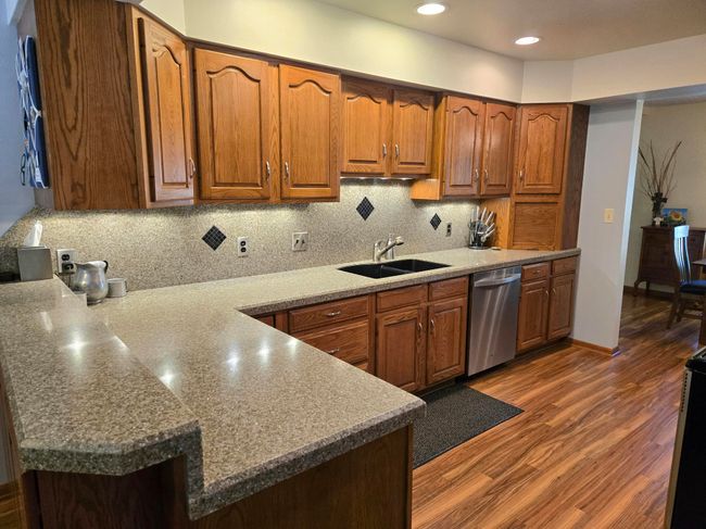 The kitchen has lots of lighting, a wonderful pantry area, lots of counter space and plenty of storage | Image 4