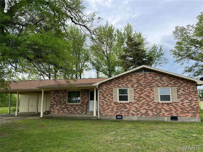 View of front of home featuring brick siding, a front yard, and an attached carport | Image 4