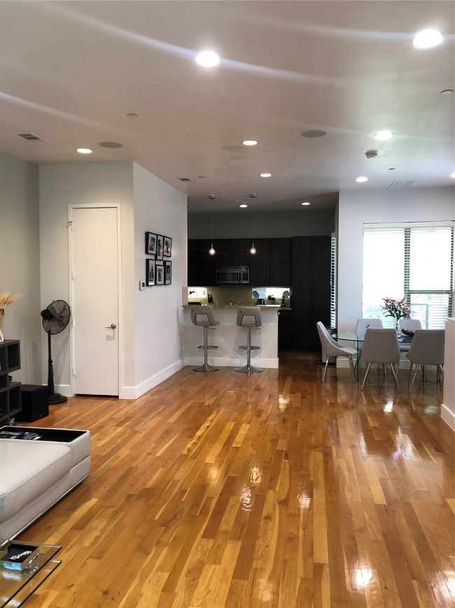 Living room with light wood finished floors and recessed lighting | Image 6