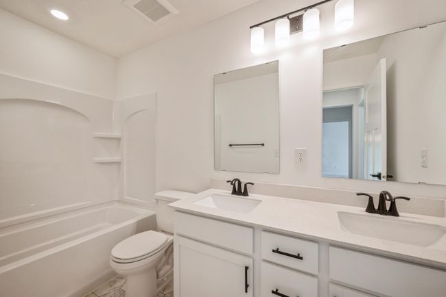 Photo is of the actual home. The secondary bath features a double-sink to make getting ready faster! | Image 14
