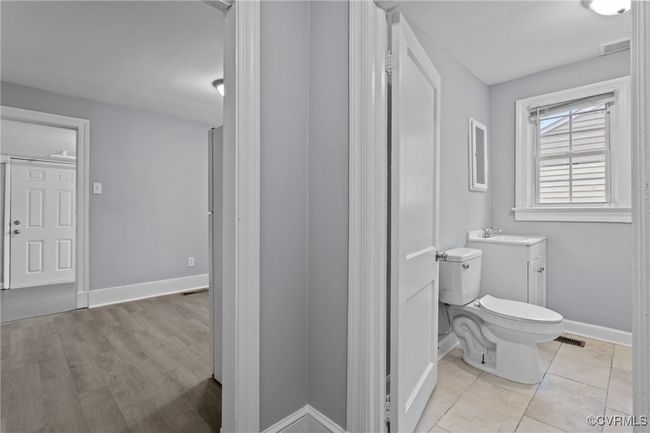 Bathroom with baseboards, visible vents, toilet, and vanity | Image 11