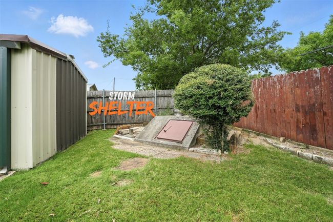 Entry to storm shelter with a fenced backyard | Image 20