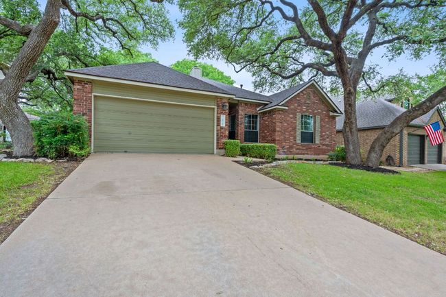 Situated on a quiet street with mature trees and sidewalks, this home offers prime access to nearby greenbelt trails and a neighborhood amenity center. | Image 7