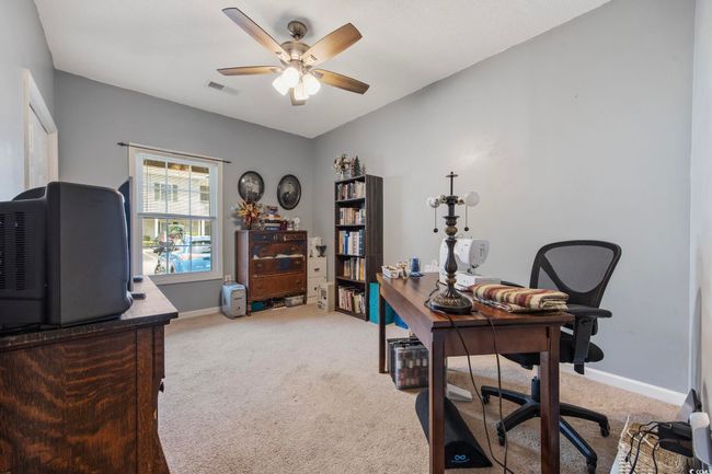 Office space featuring light carpet, ceiling fan, and baseboards | Image 17