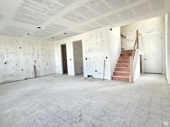 Unfurnished living room with stairway | Image 7
