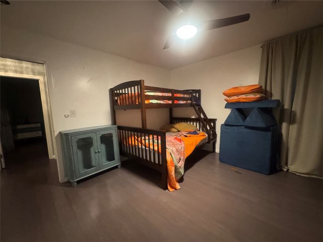 Bedroom featuring wood finished floors and ceiling fan | Image 28