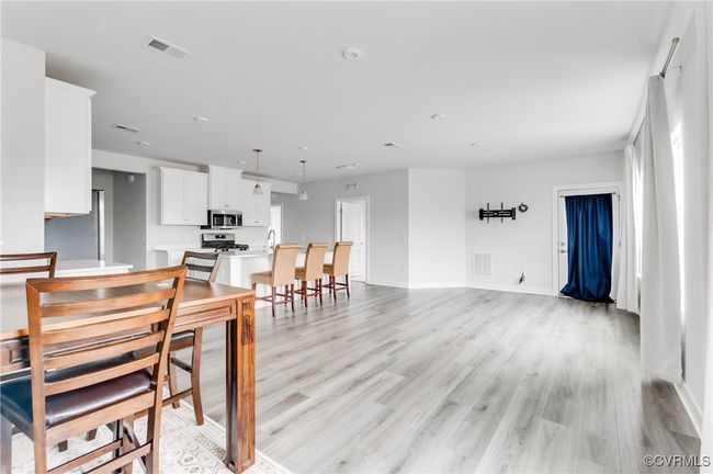 Dining room with light wood-style flooring and baseboards | Image 6