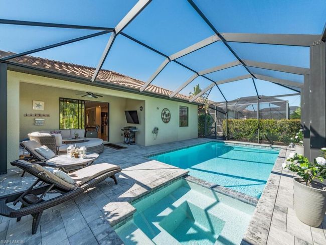 View of pool featuring ceiling fan, a patio, outdoor lounge area, area for grilling, and a pool with connected hot tub | Image 12