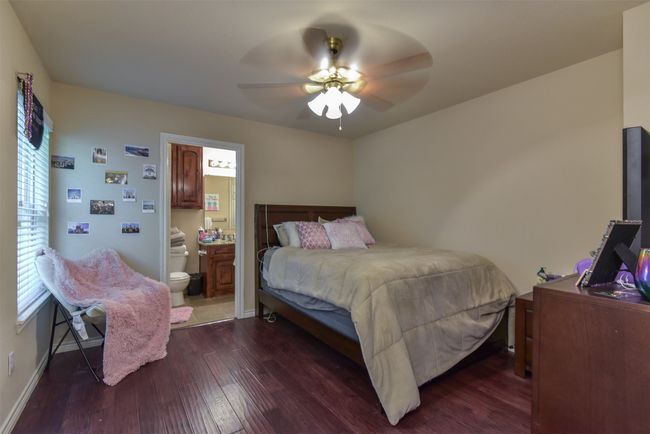 Bedroom with ceiling fan, ensuite bathroom, and hardwood / wood-style flooring | Image 10