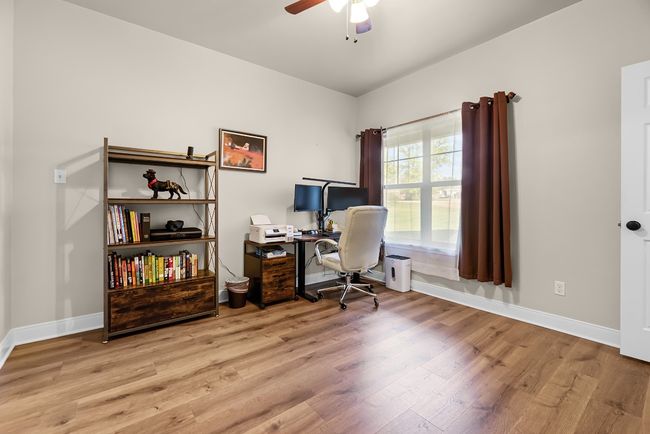 Office space with baseboards, a ceiling fan, and wood finished floors | Image 16