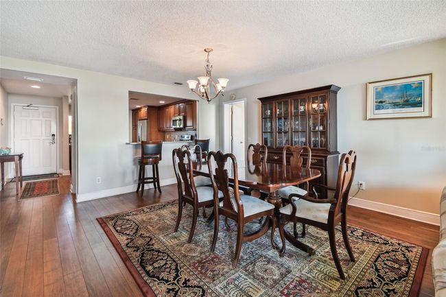 View of the dining room and breakfast bar looking into the kitchen. | Image 21