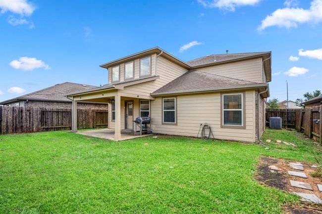 The backyard is fully fenced and offers a fun and safe environment for children and pets to play. | Image 42
