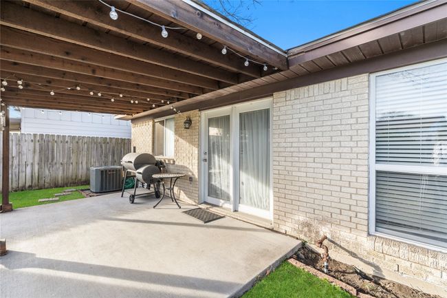 View of patio featuring grilling area and central air condition unit | Image 24